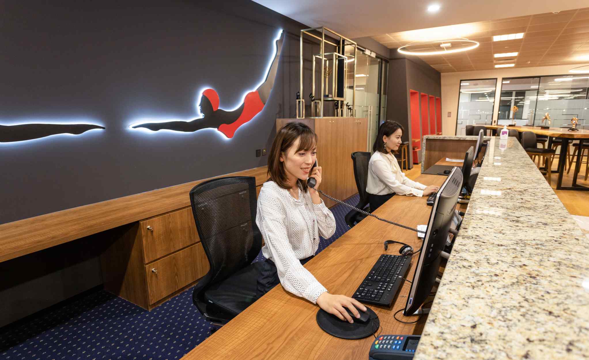 A professional receptionist answering phone calls at Servcorp, One Museum Place, Shanghai, China. 