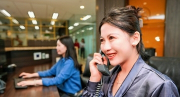 Dedicated receptionist answering phone calls at Servcorp, Fortune Financial Center, Beijing, China.